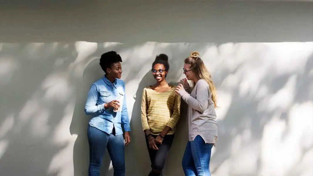 Three students enjoying conversation